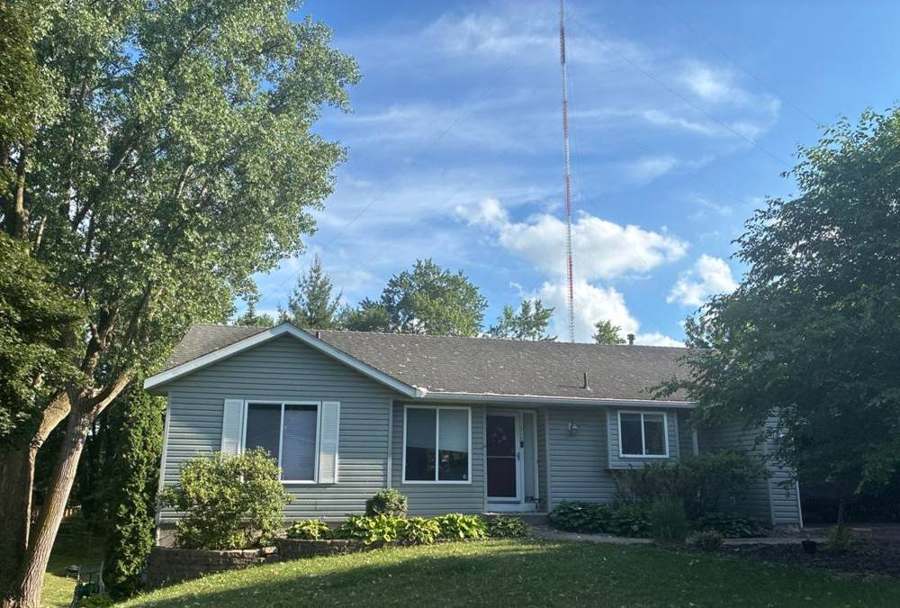 Single-level home with light vinyl siding and mature trees on Suzanne Avenue in Shoreview, MN, June 2026