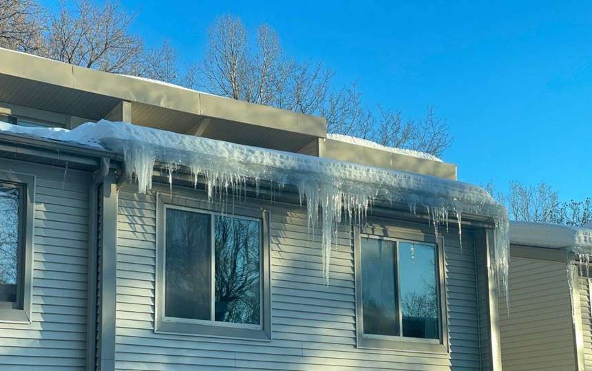 Icicles and ice dam along the gutter of a Wildwood Townhomes building in Apple Valley, February 2023
