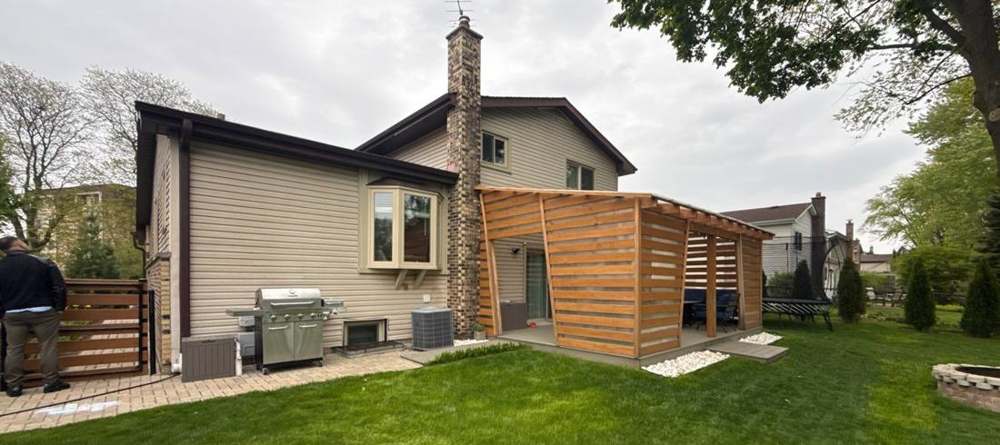 Backyard and roofline photographed during an Arlington Heights project, May 2026