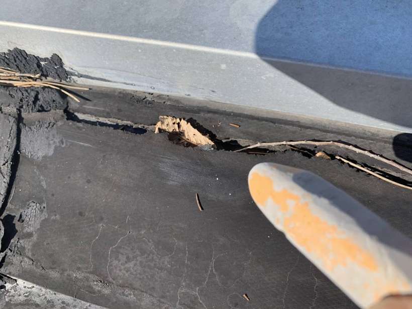 An open seam at the metal edge of the Washington Place rubber roof in St. Cloud