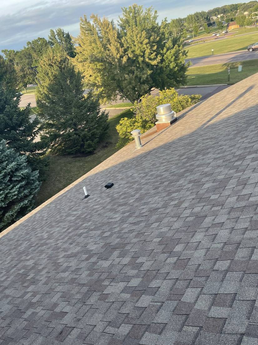 Shingle roof and evergreens at the GrandStay Hotel in Waseca