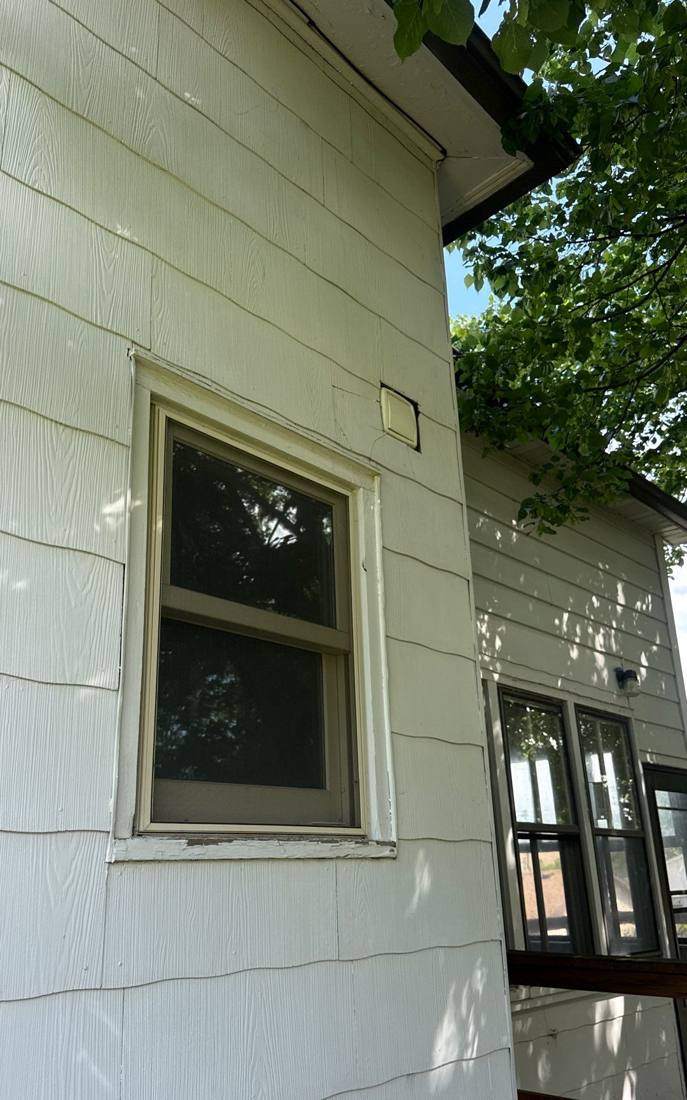 Siding and window trim on a New Ulm home during a roof and siding inspection, May 2026