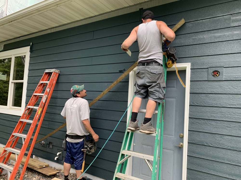 Repair King crew installing LP SmartSide lap siding around a door on a Ramsey, MN home, June 2019