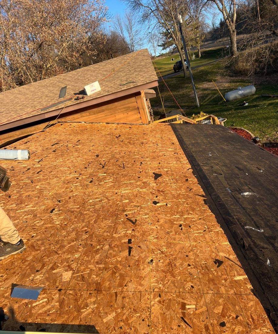 New roof decking going down near a log-sided home outside Dassel, November 2023