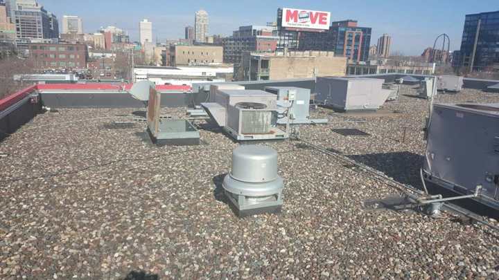 Exhaust fans and rooftop units on the ballasted roof at Bobby & Steve's on Washington Avenue, downtown Minneapolis