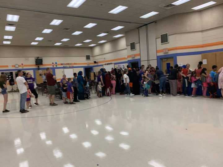 Families lining up for backpacks and school supplies in the Talahi gym in St. Cloud, August 2019