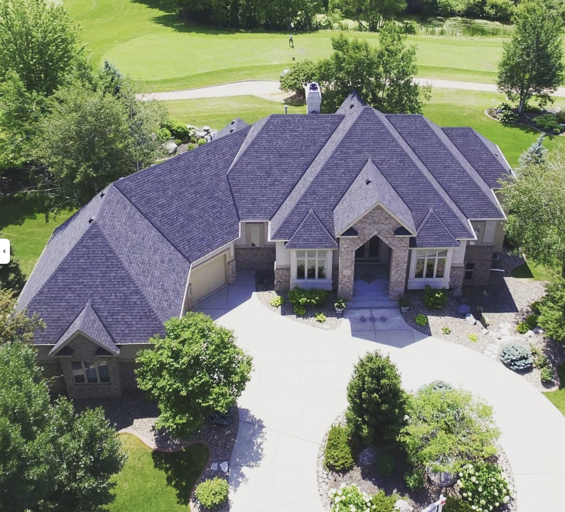 New architectural shingle roof on a custom home, aerial drone photo