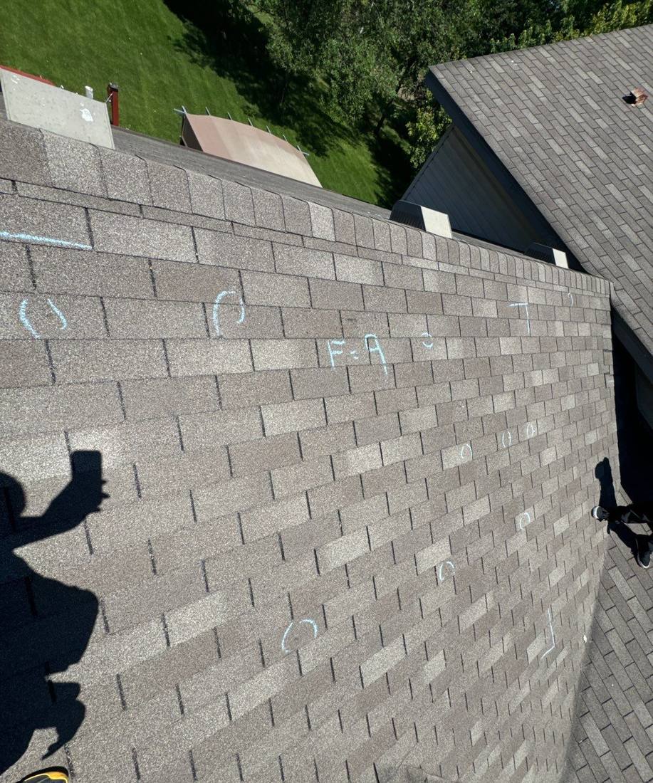 Multiple chalk-marked hail hits across an Oak Grove roof slope, June 2024