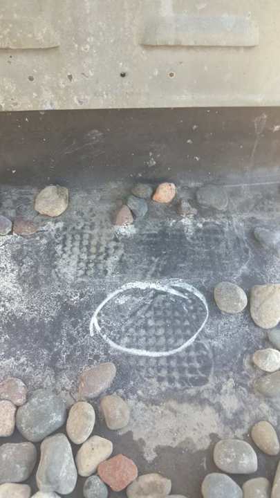 Chalk-circled spot on the membrane flashing at a rooftop unit curb, Bobby & Steve's, downtown Minneapolis