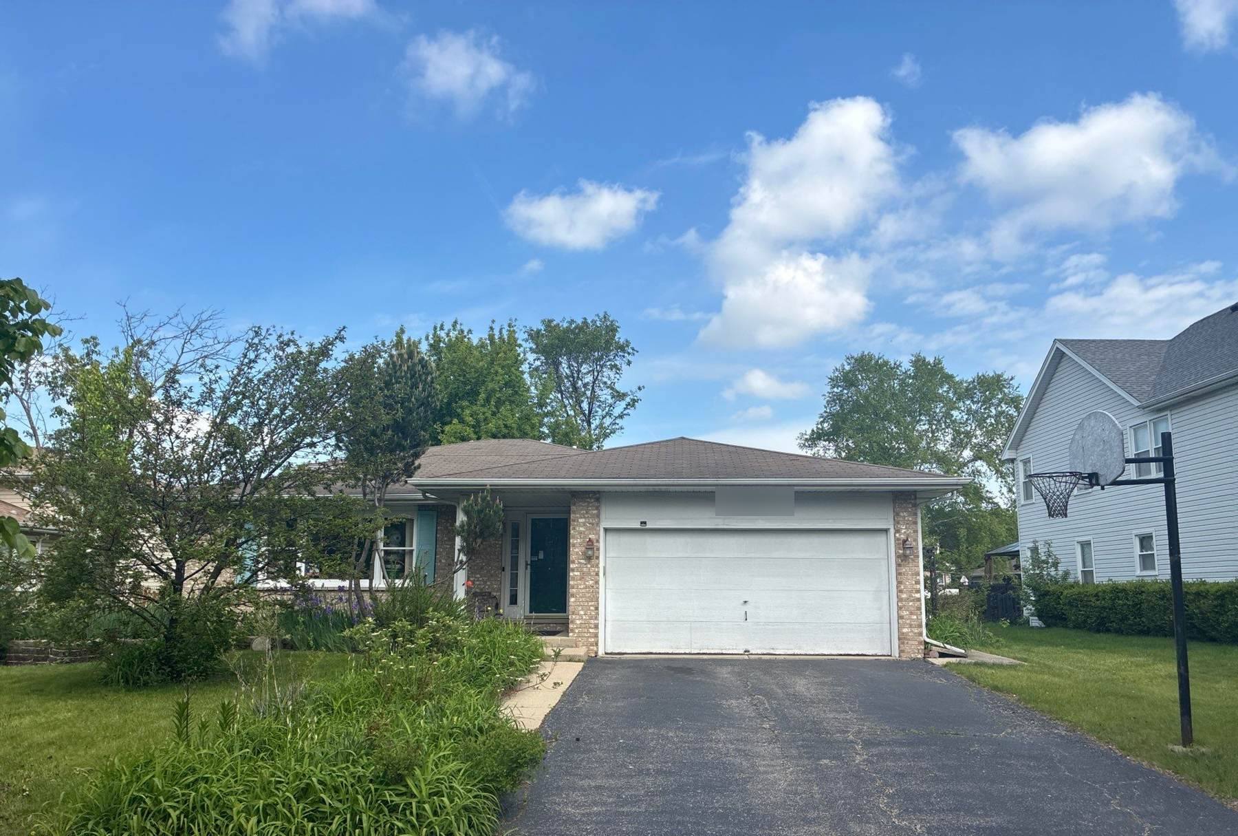 Ranch home in Bolingbrook with new roof, blue sky and basketball hoop in the driveway, May 2026