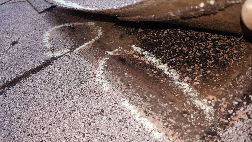 Chalk marks on a damaged shingle at Red Rock Lodge, Newport