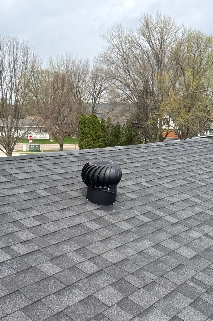 Black turbine vent on the gray shingle roof of Valley View Assembly of God in Lake City, MN, during Repair King's April 2026 roof check