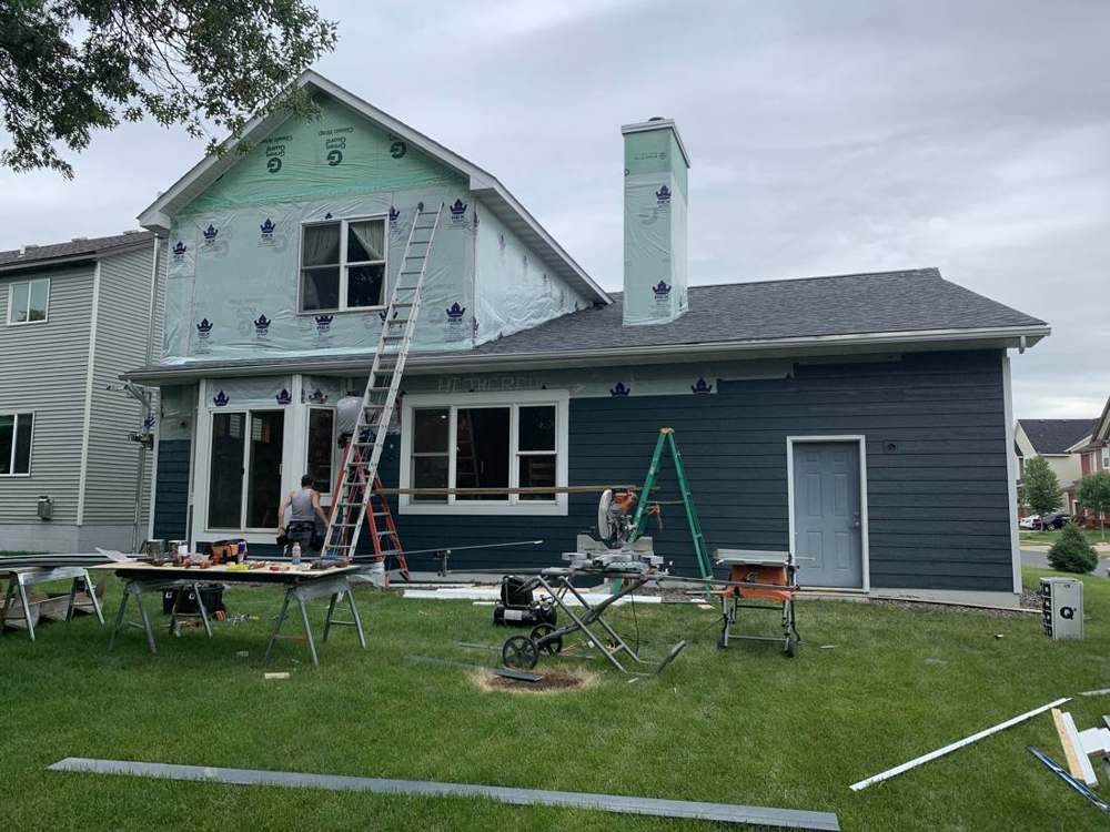 Old siding off and house wrap exposed during a Ramsey re-siding job, June 2019