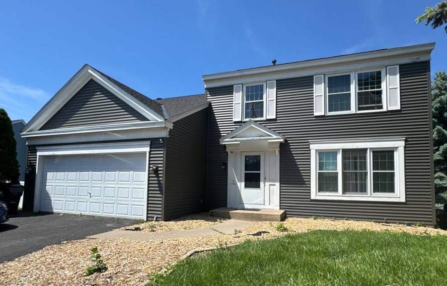 Two-story home off Crestview Drive in Maplewood, MN with new dark shingles and gray siding, May 2024