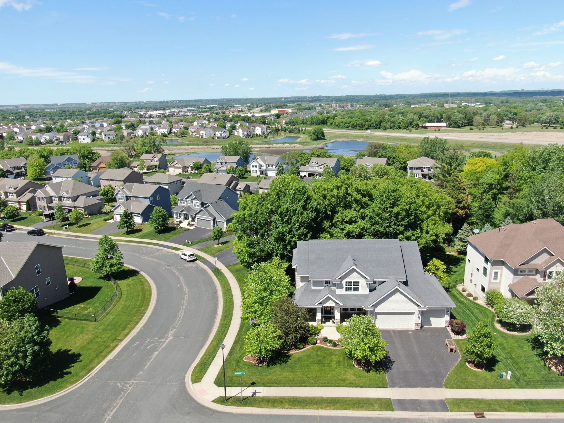 Drone view of a Twin Cities home and neighborhood during a Repair King roof inspection
