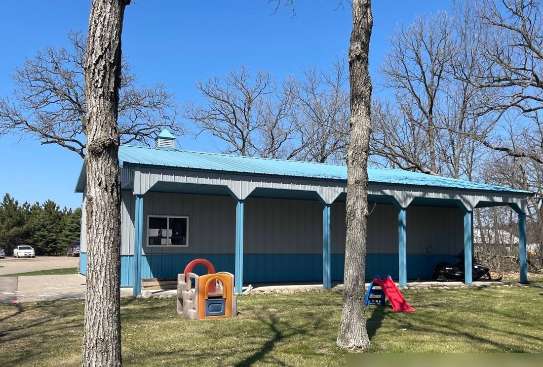 Pole barn with a covered porch on a Royalton-area property, photographed during a roof inspection, May 2022