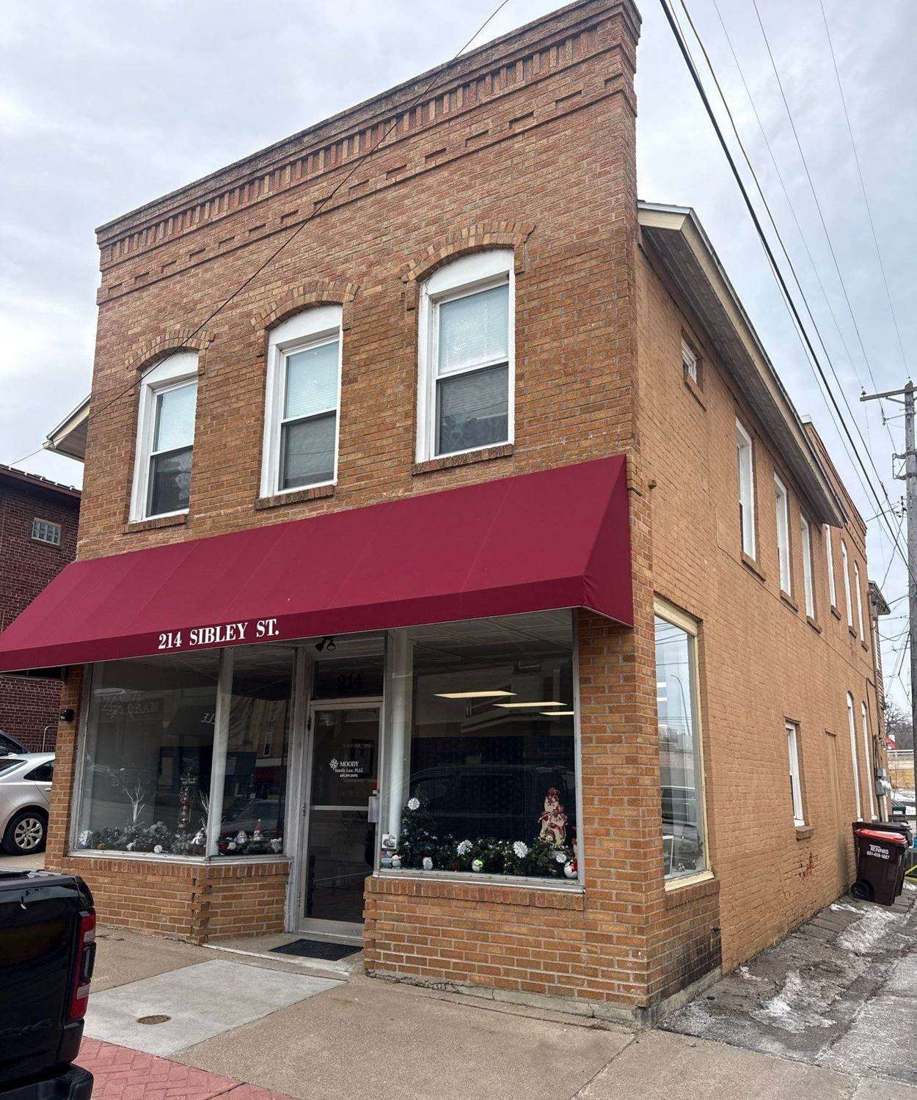 Two-story brick commercial building at 214 Sibley St in downtown Hastings, MN, photographed by Repair King during a 2026 roof inspection