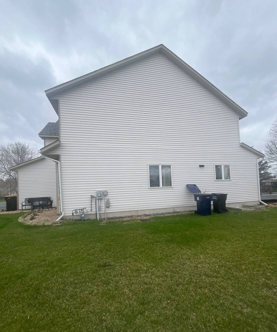 Rear elevation of a Shakopee home photographed during a roof inspection, April 2024