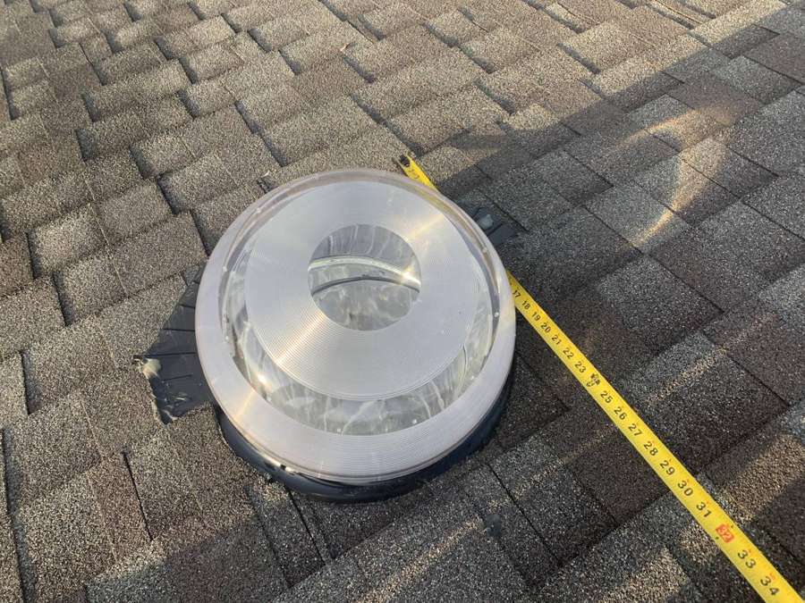 A skylight dome measured with a tape on a Penn Place roof