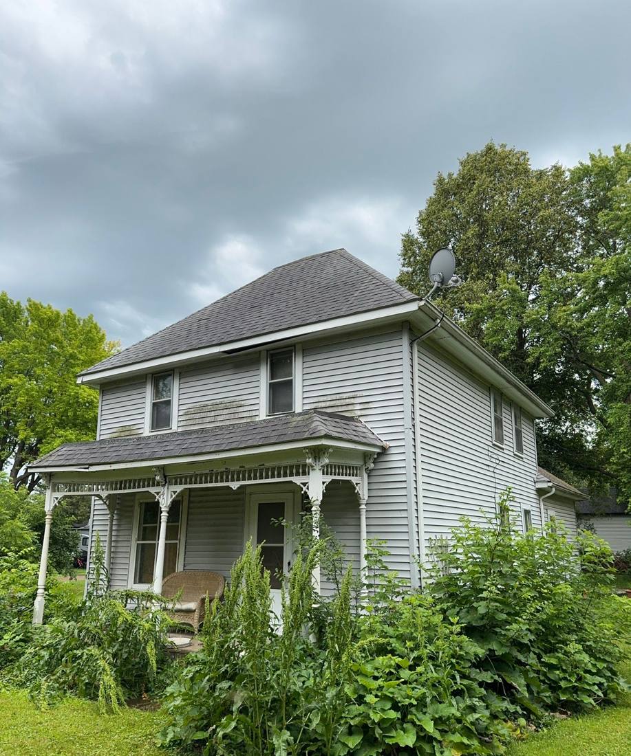 Two-story farmhouse-style home in Cokato photographed during a roof project, July 2024