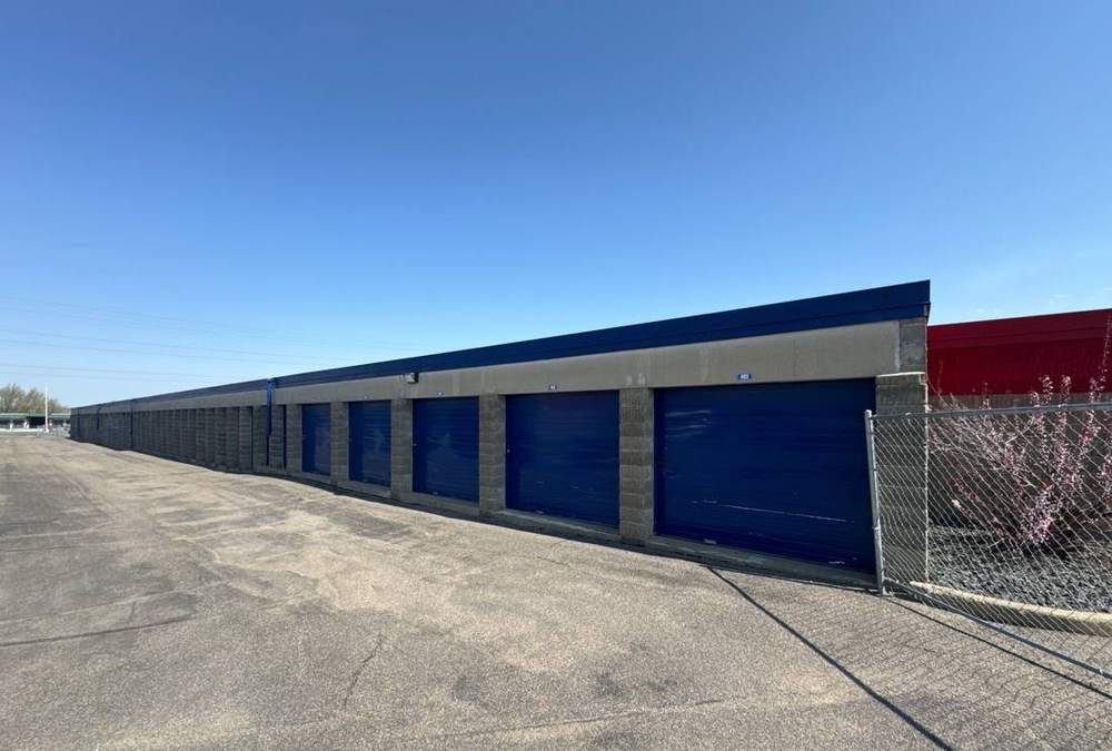 Row of storage units and low-slope roof edge at an iStorage facility in Burnsville, inspected by Repair King in April 2024