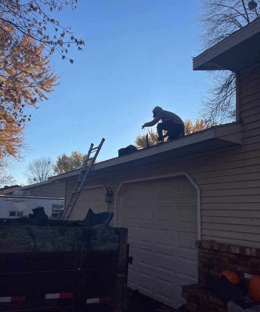 Repair King crew member working a garage roof tear-off in Buffalo, October 2021