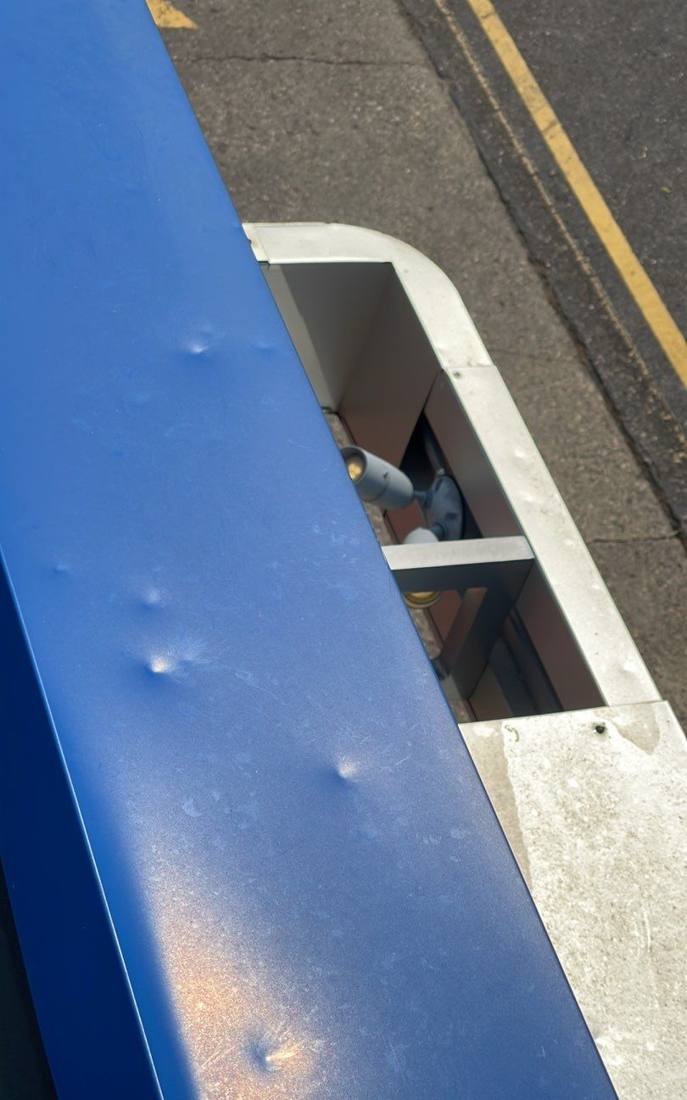 Hail dents in the metal coping at Cokato's Dairy Queen, July 2023