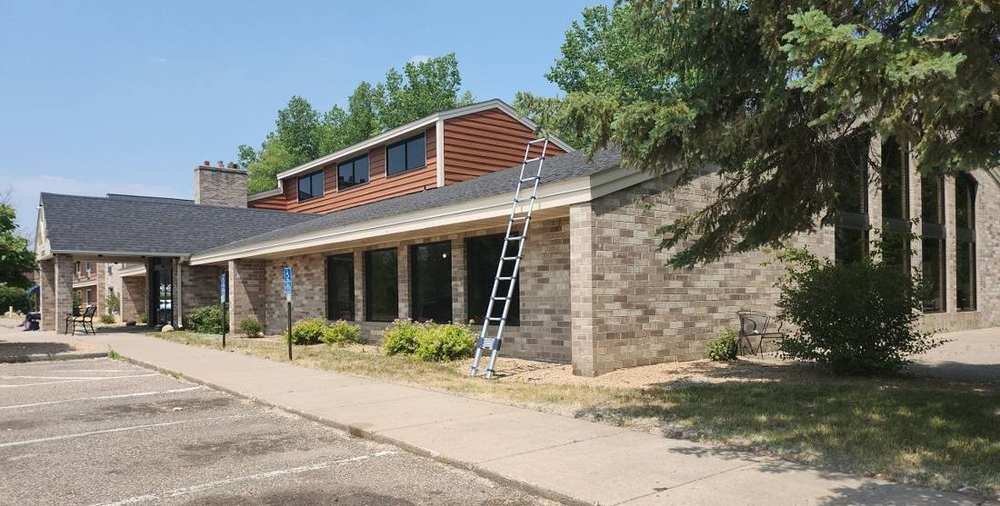 Exterior of the AmericInn by Wyndham hotel on White Bear Parkway in White Bear Lake, MN, photographed during a Repair King roof inspection, June 2023