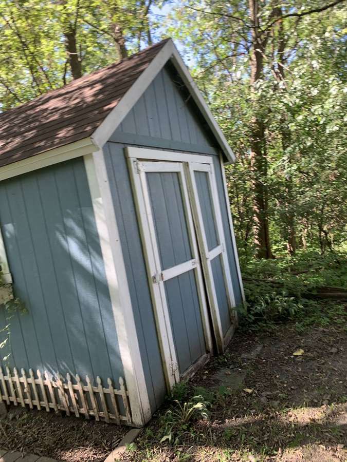 Garden shed with a shingle roof on a Watertown property
