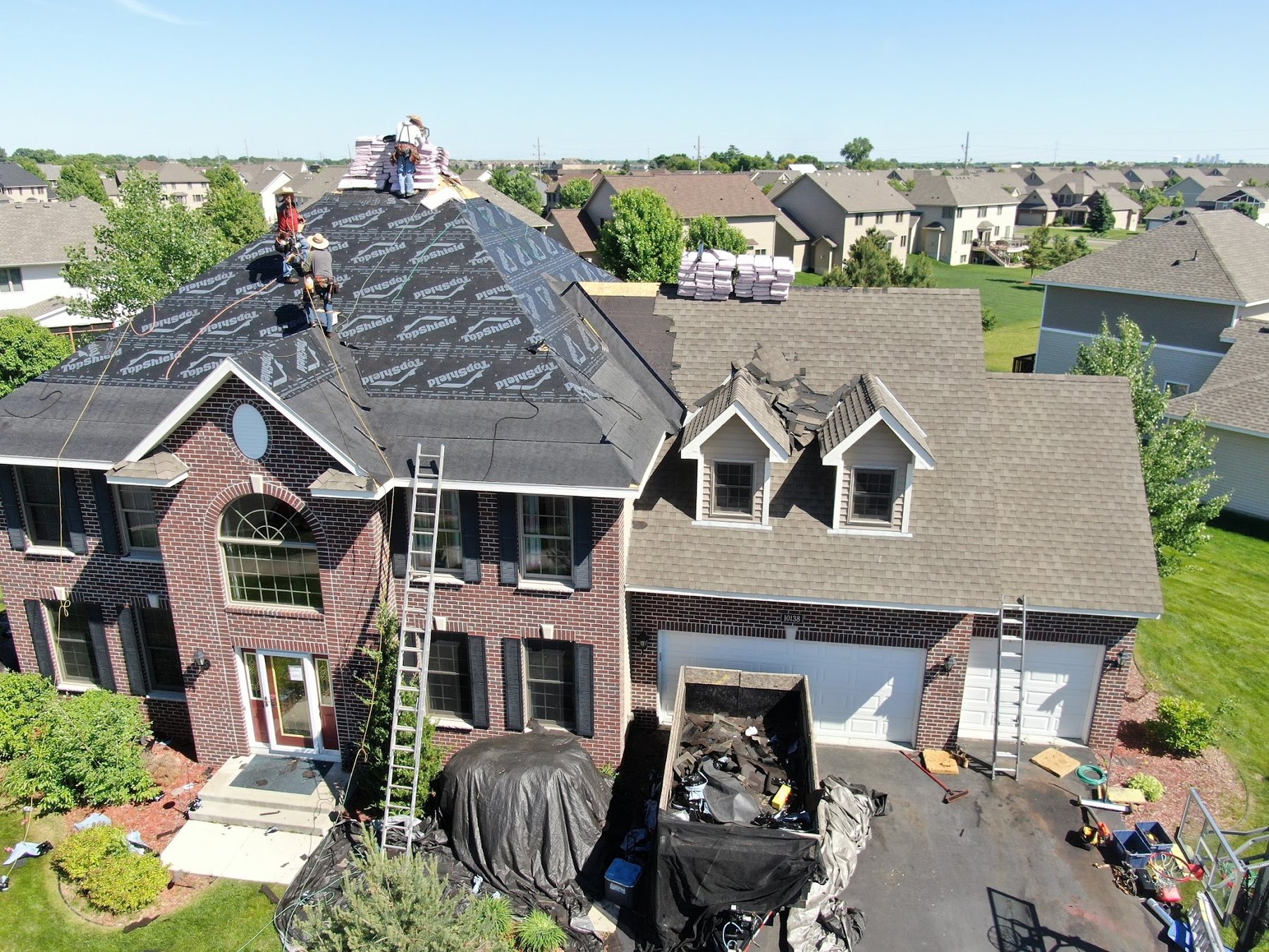 Repair King crew tearing off an old roof on a Minnesota home