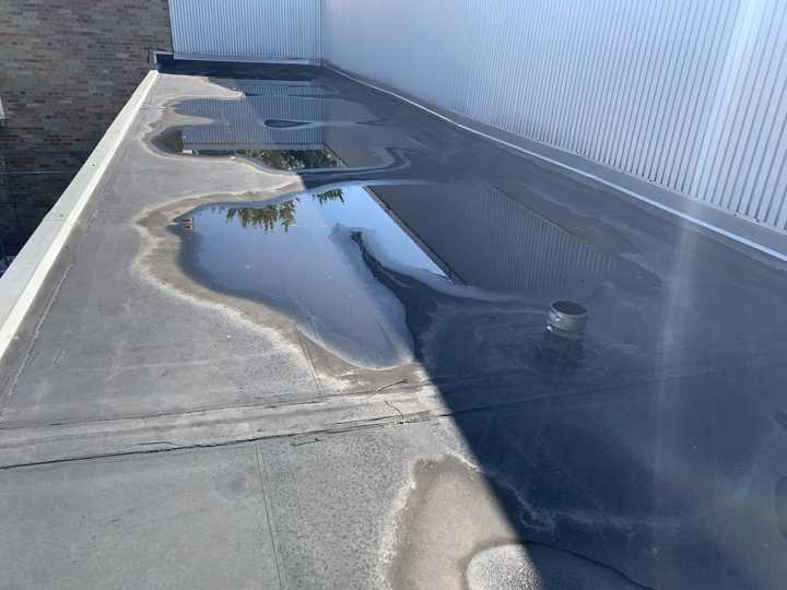 Standing water along the wall of a Washington Place roof section in St. Cloud, September 2019