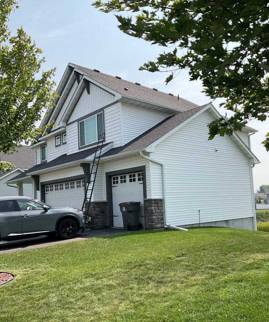 Side view of a two-story home in Prior Lake during a roof inspection, August 2023