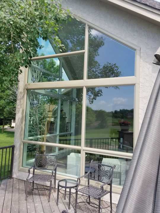 Tall wall of aluminum-clad windows and a patio door on a Prior Lake golf course home, May 2018