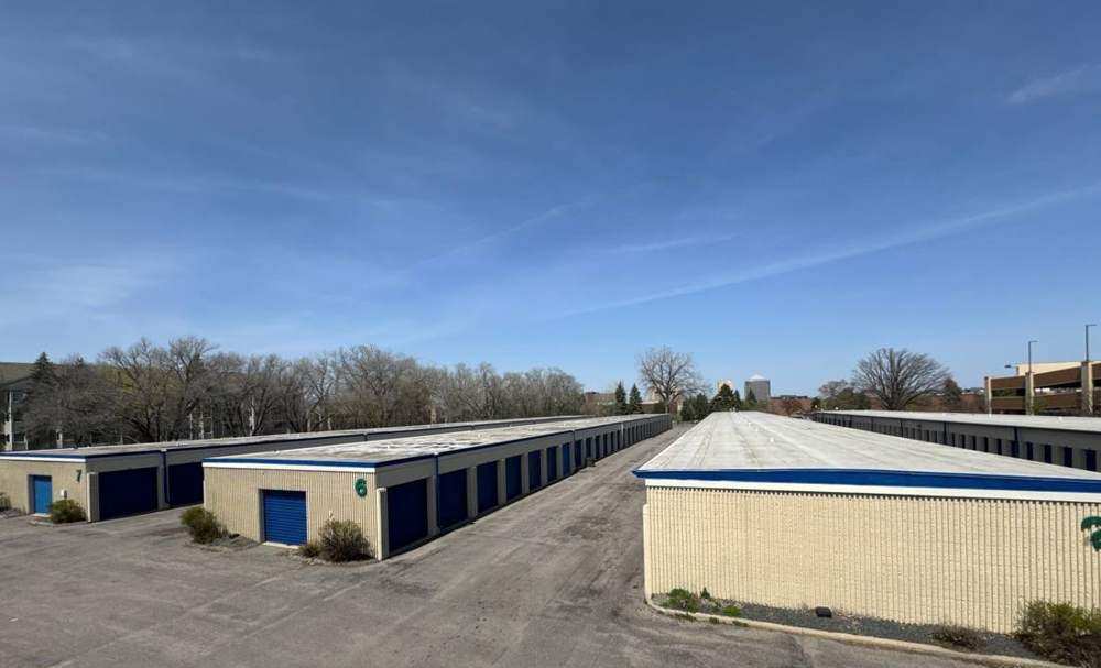 Wide view of a low-slope commercial roof at iStorage self-storage in St. Louis Park, MN, with the downtown skyline in the background