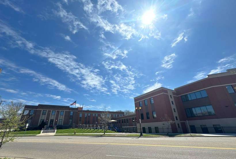 Street view of HOPE Community Academy on Payne Avenue in St. Paul, showing the original brick school and the newer three-story addition, April 2024