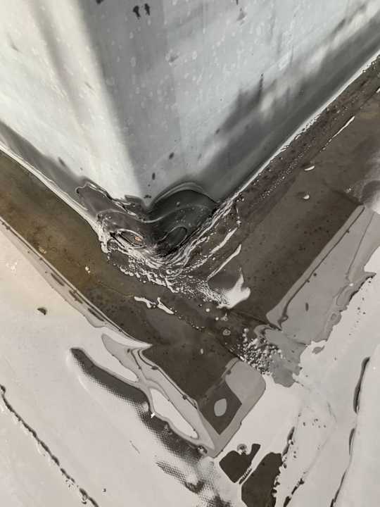 Split seam at an inside corner of the rubber membrane on the Eide Chrysler roof in Pine City, MN, July 2019
