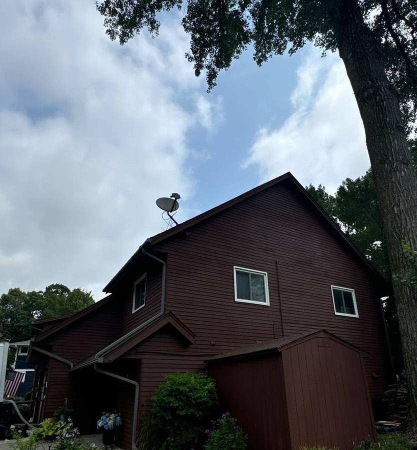 Multi-level lake-area home in Mound photographed during a roof and chimney project, July 2024