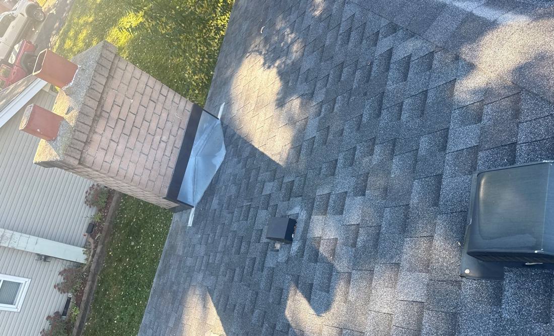 Chimney flashing and roof vents on a Lakeville home during an inspection, October 2025