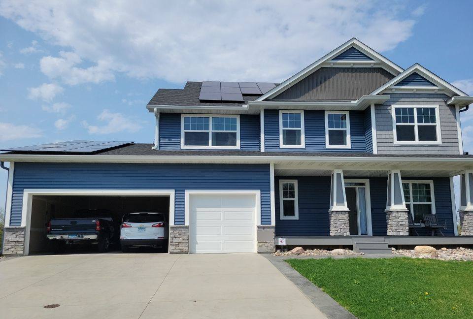 Blue two-story Shakopee home with solar panels, photographed during a roof project, May 2022