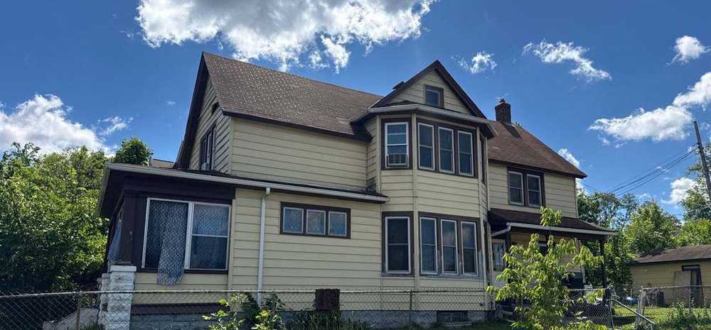 Two-story Victorian-era home near Sims Avenue on St. Paul's East Side, photographed during a roof project, June 2026