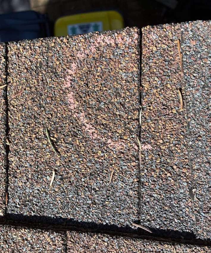 Hail hit chalk-marked on a Chisago City roof slope during an inspection, June 2026