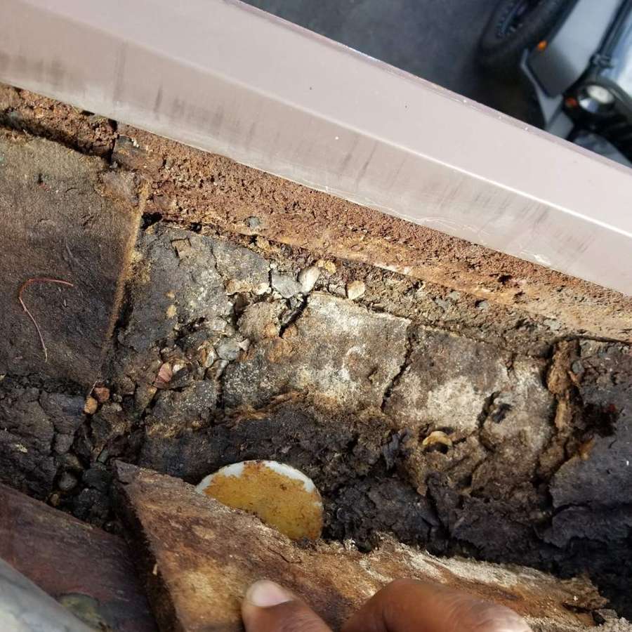 Deteriorated wood and insulation found under edge flashing on the West St. Paul roof