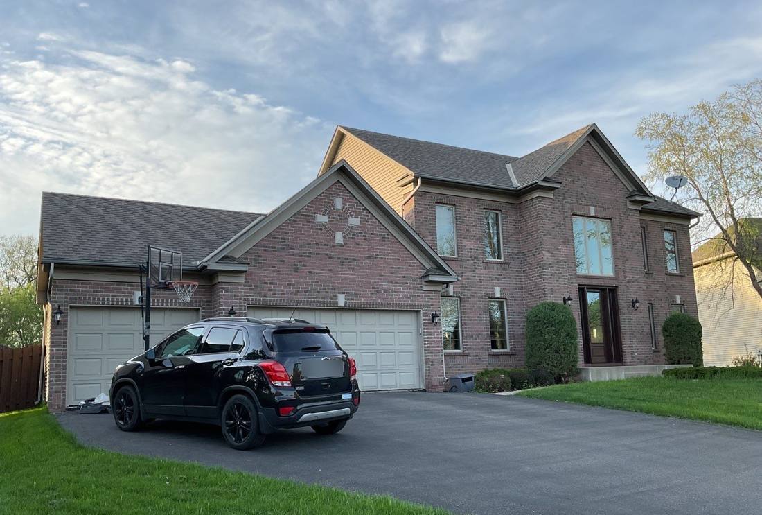 Two-story brick home in Savage during a Repair King roof inspection, May 2023
