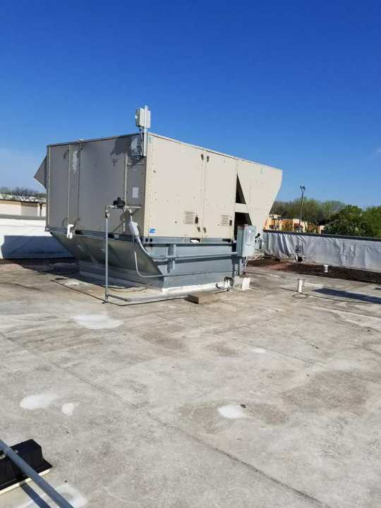 Rooftop HVAC unit on the flat membrane roof of the Good Earth restaurant building on Highway 36 in Roseville, MN, during a Repair King inspection