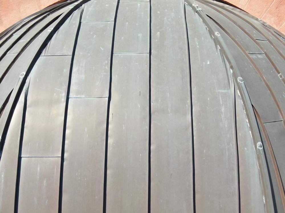 Close-up of curved copper dome panels