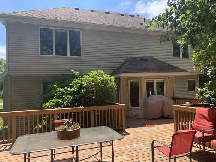 The rear deck and back wall of the Plymouth home during wall and window measurements, July 2020