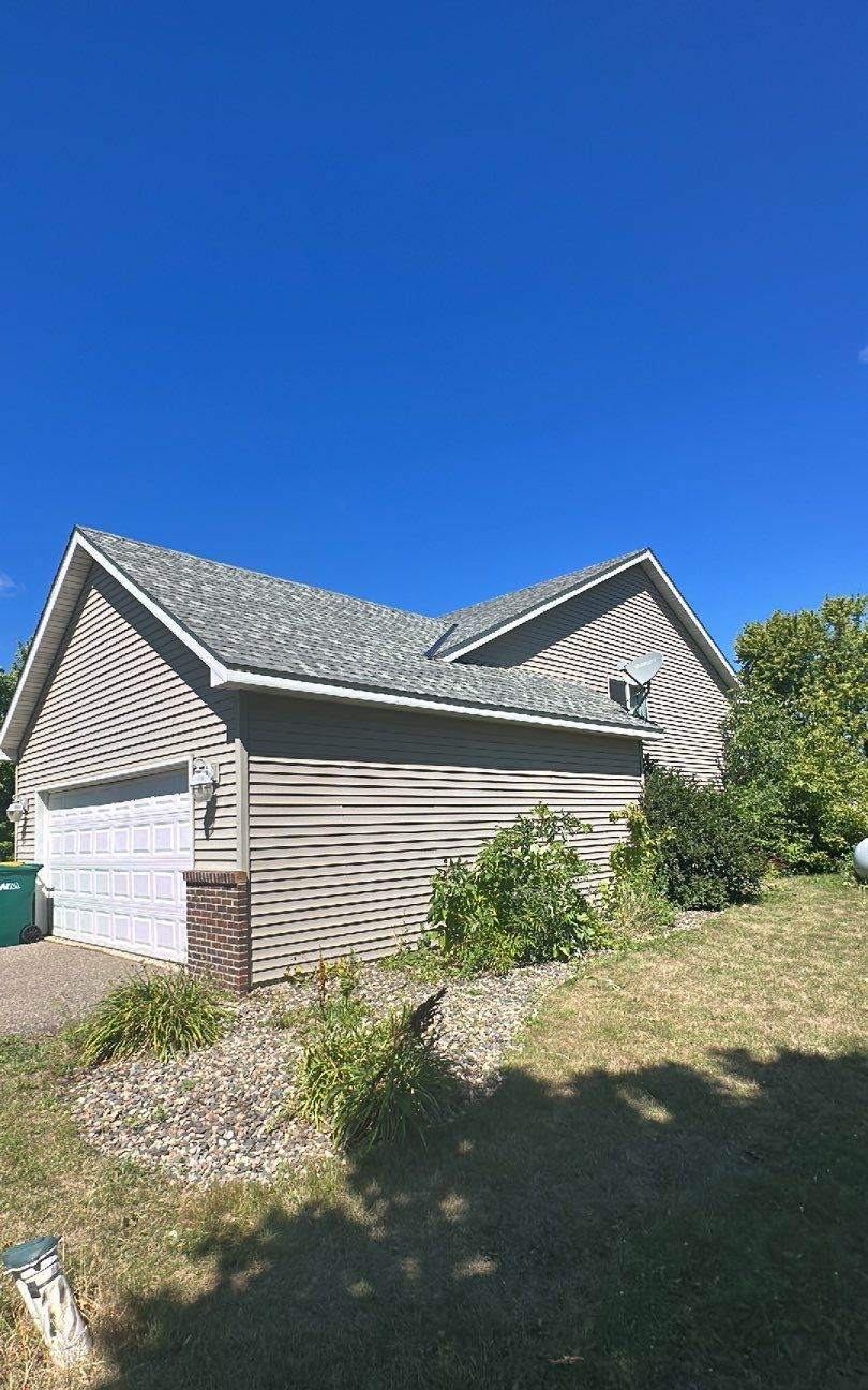 Two-story home near Dassel during a roof project, August 2023