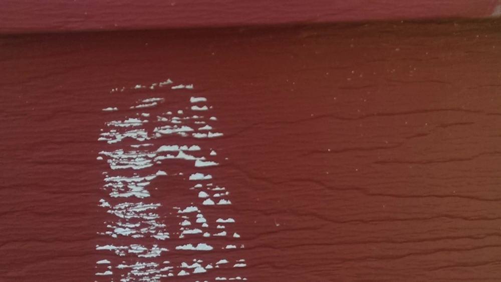 Chalk-marked hit on the old red lap siding of the Hinckley home before new siding went on