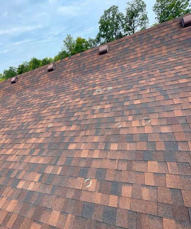Chalk-marked hail hits on the shingle roof of Cascade United Methodist Church in Deerwood, MN