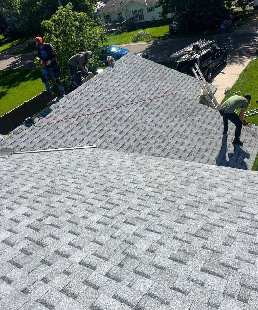 Repair King crew tearing off shingles on a Dennison roof, June 2024
